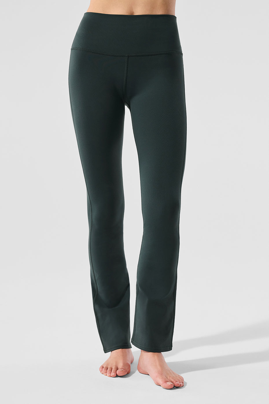 Side angle showing the bootcut design and wide waistband on activewear leggings