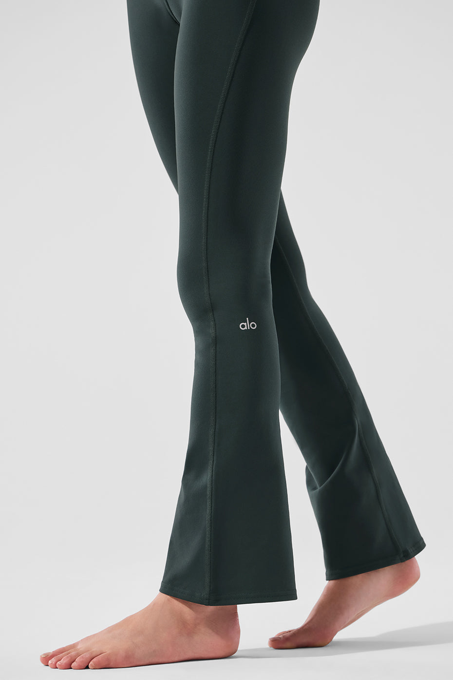 Side angle showing the bootcut design and wide waistband on activewear leggings