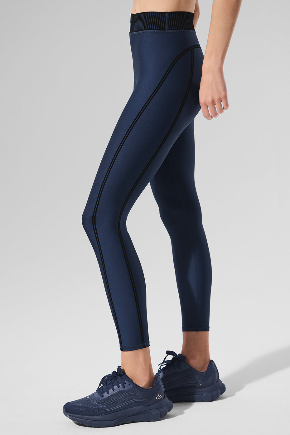 Model showcasing navy workout leggings during a yoga session.