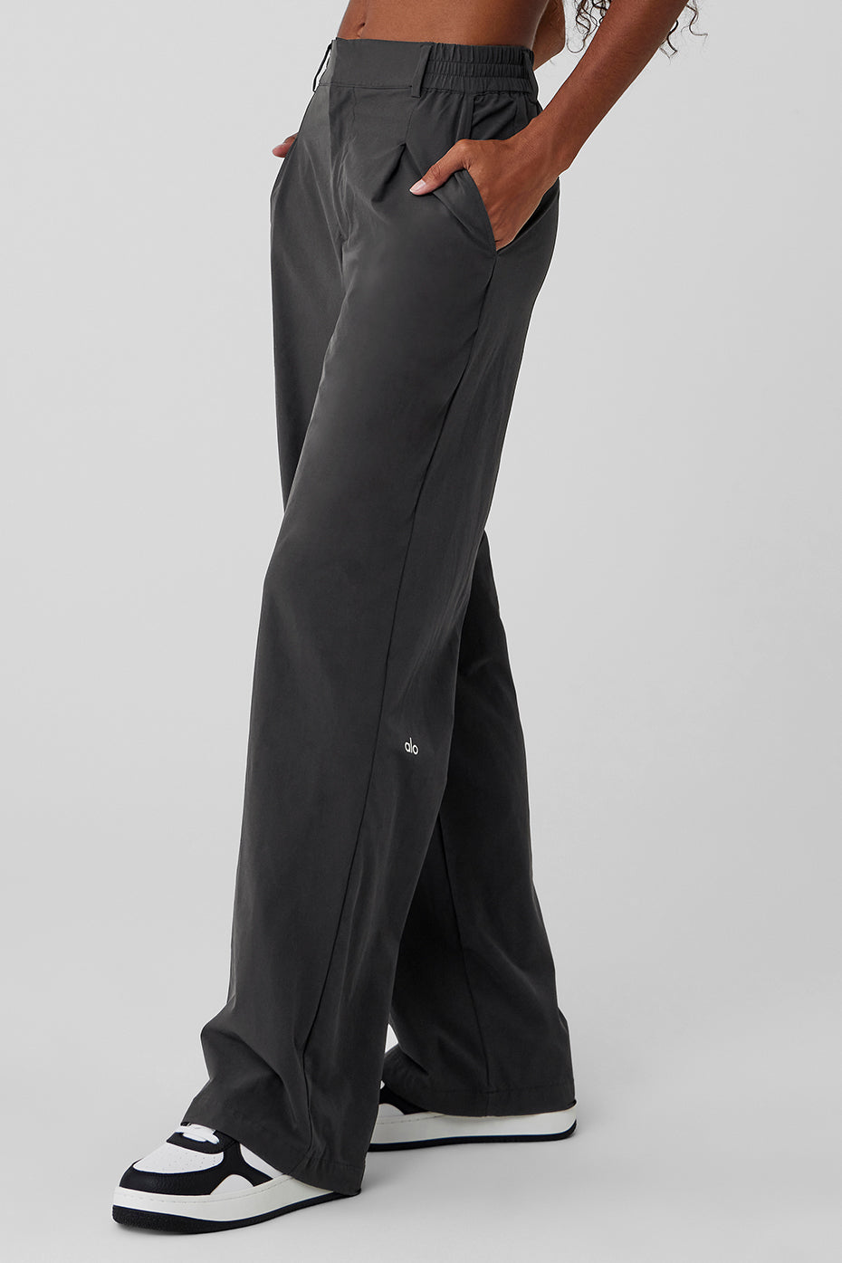 Close-up of the high-rise waistband and pleat details.