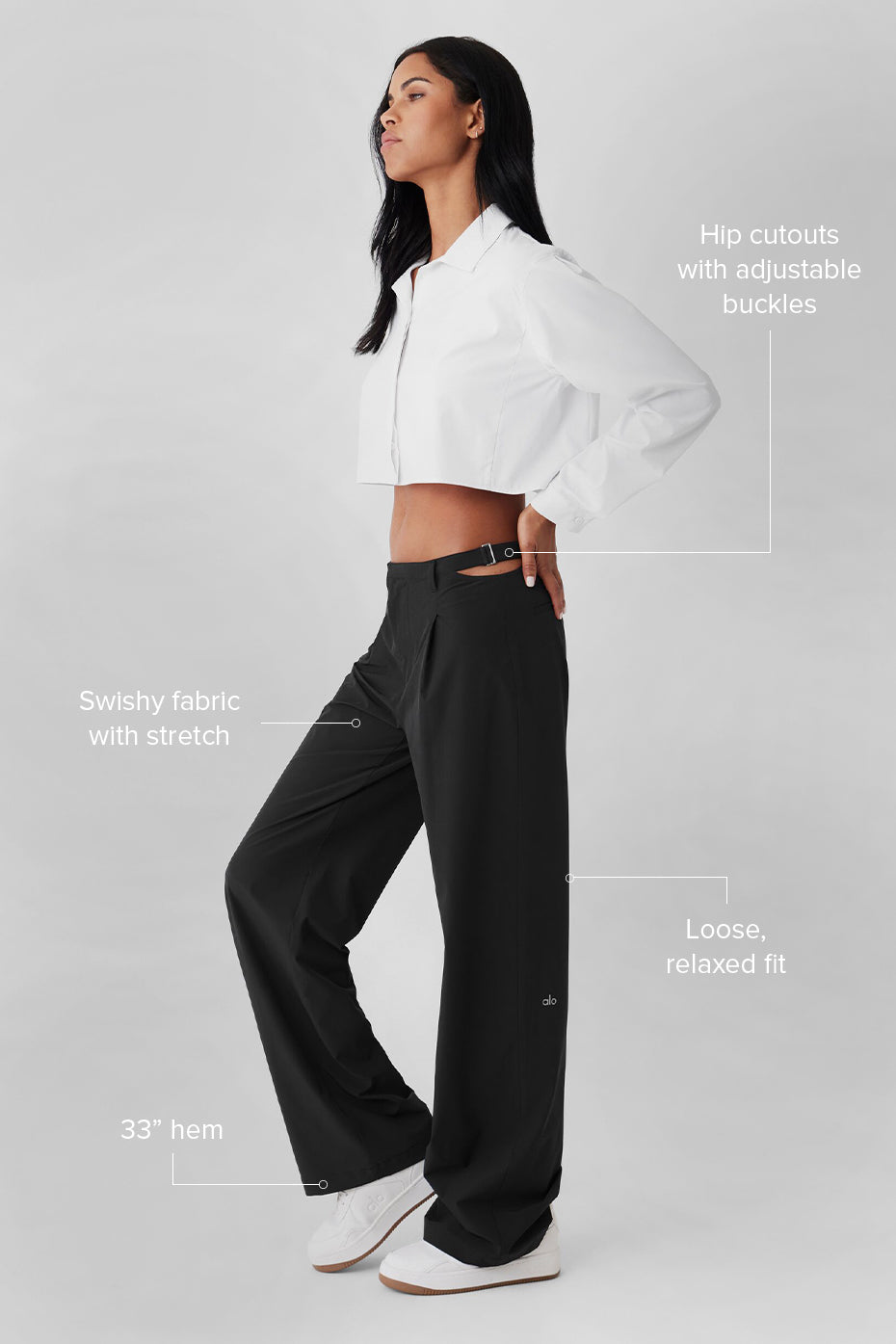 Side angle of chic trousers showcasing adjustable buckles and sleek design.