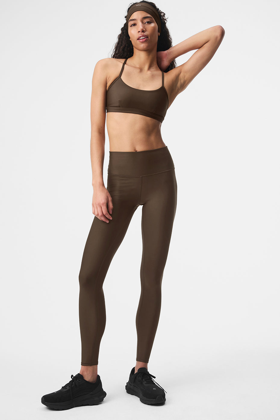 Side angle showing sculpted fit of athleta leggings in espresso tone