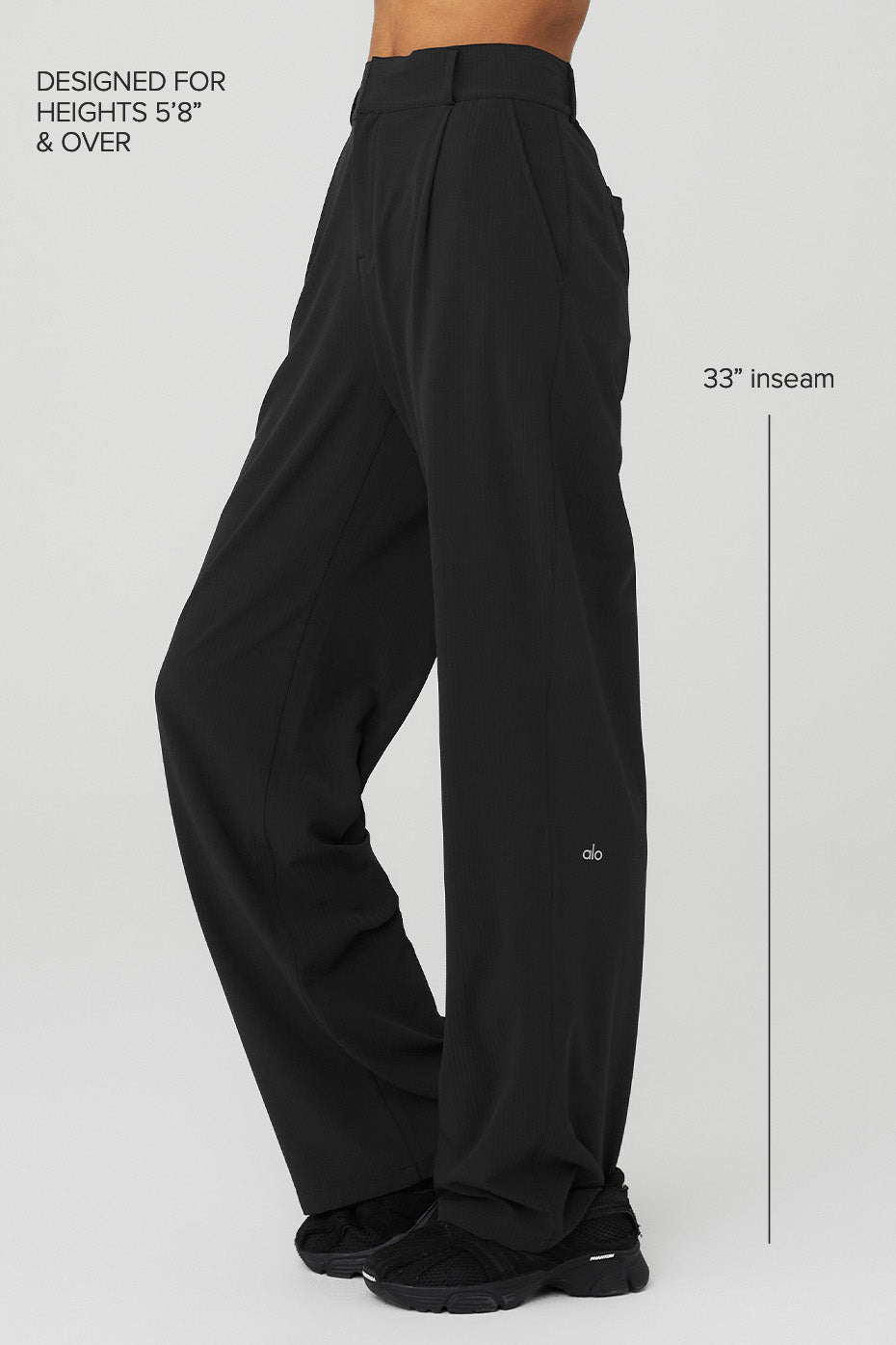 Side angle of the trousers, highlighting the elegant pleats and sleek design.