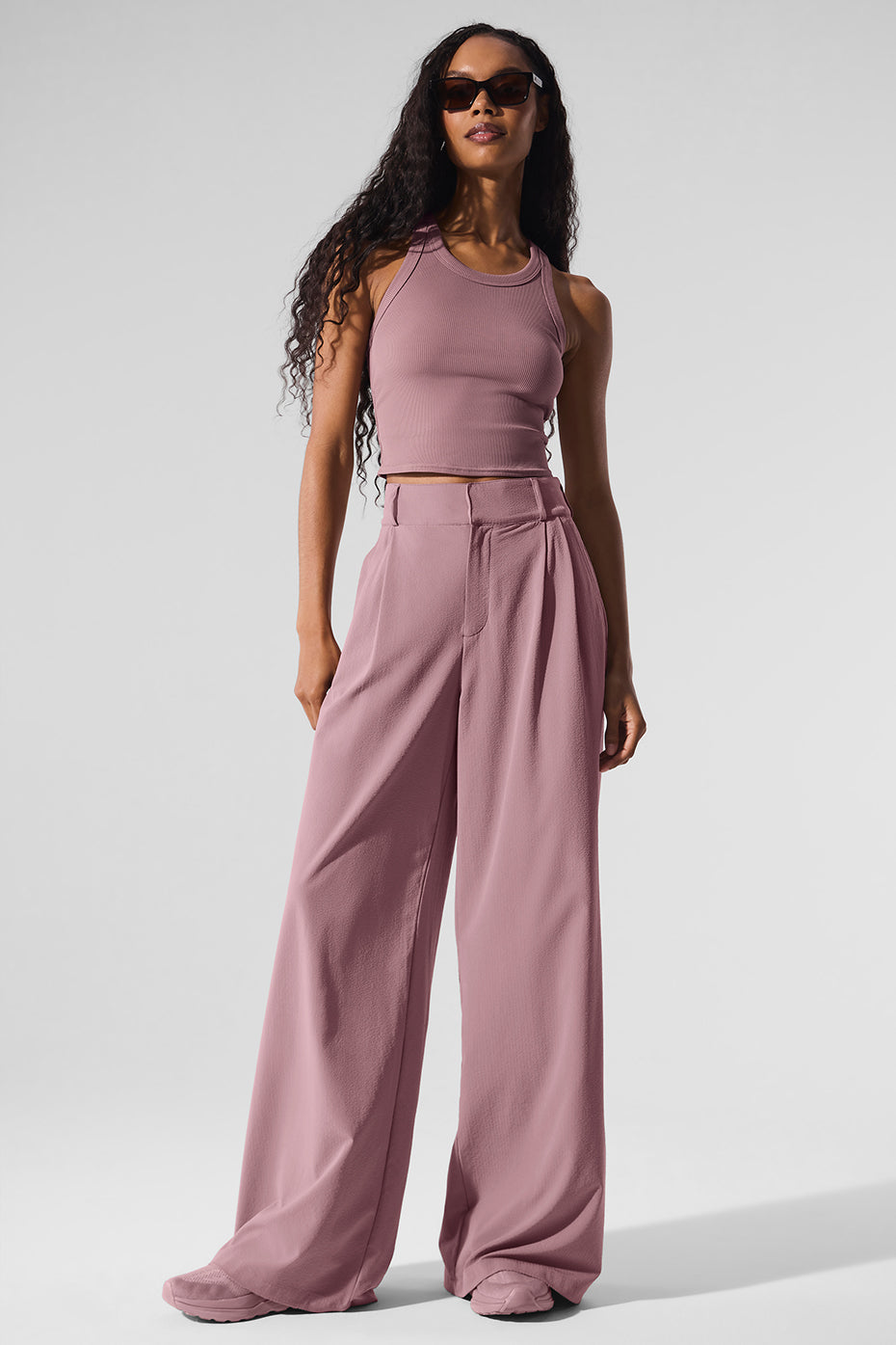 Front view of high-waisted trousers on female model in urban setting