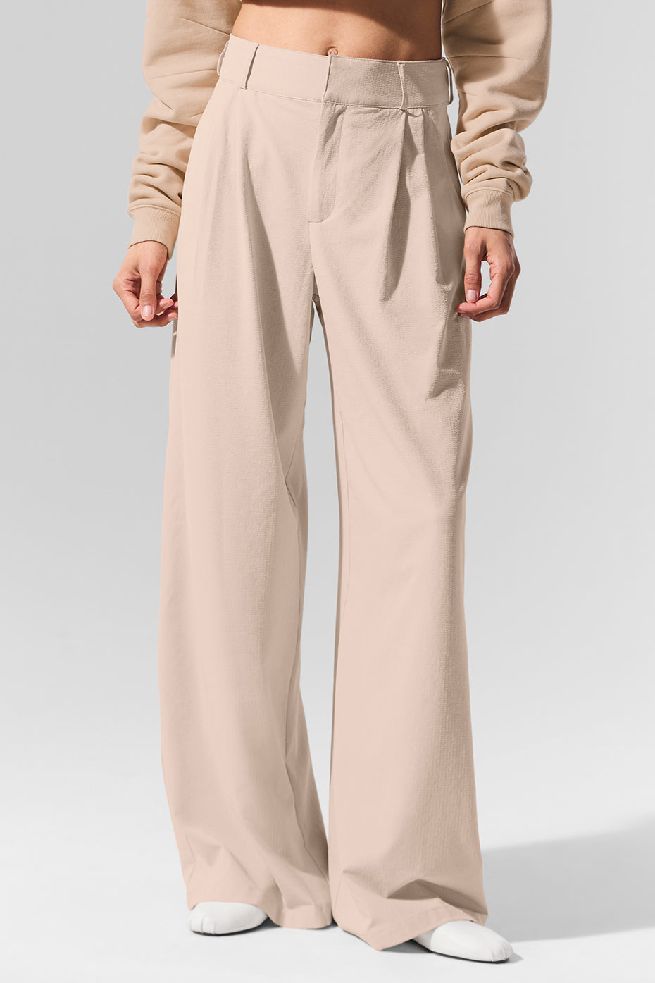 Front view of high-waist pleated trousers with wide-leg cut, perfect for office or casual outings