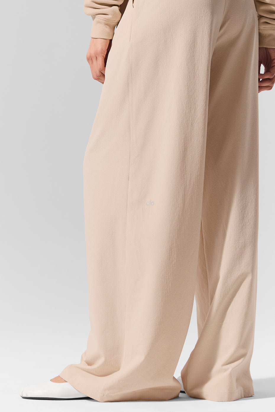Front view of high-waist pleated trousers with wide-leg cut, perfect for office or casual outings