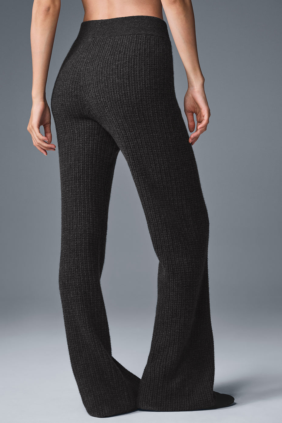 Close-up of the soft waffle knit texture of high-waisted pants for guys.