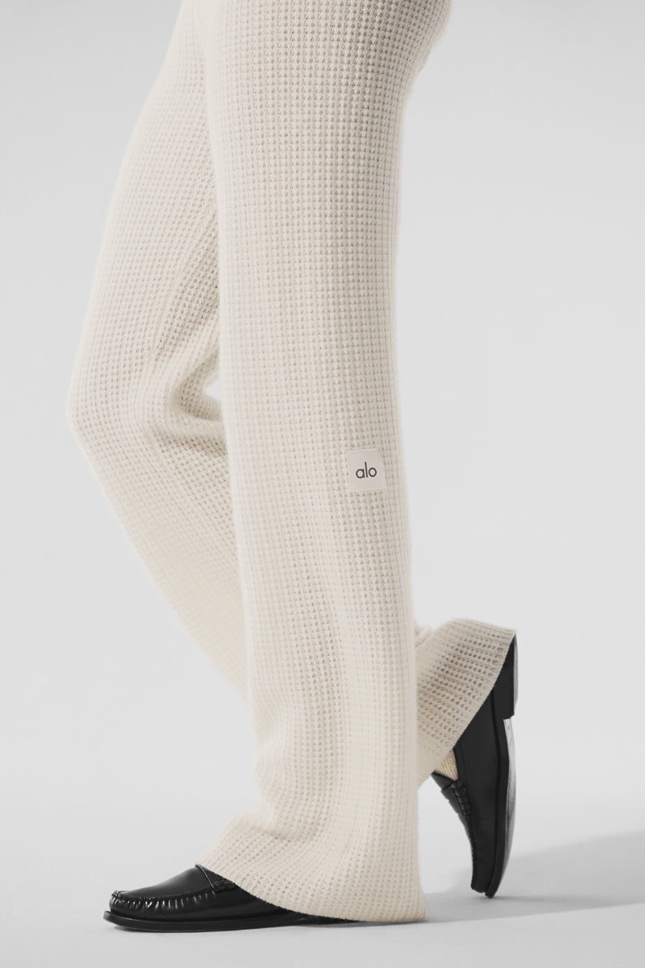 Front view of ivory cashmere pants ladies love, worn with cropped sweater