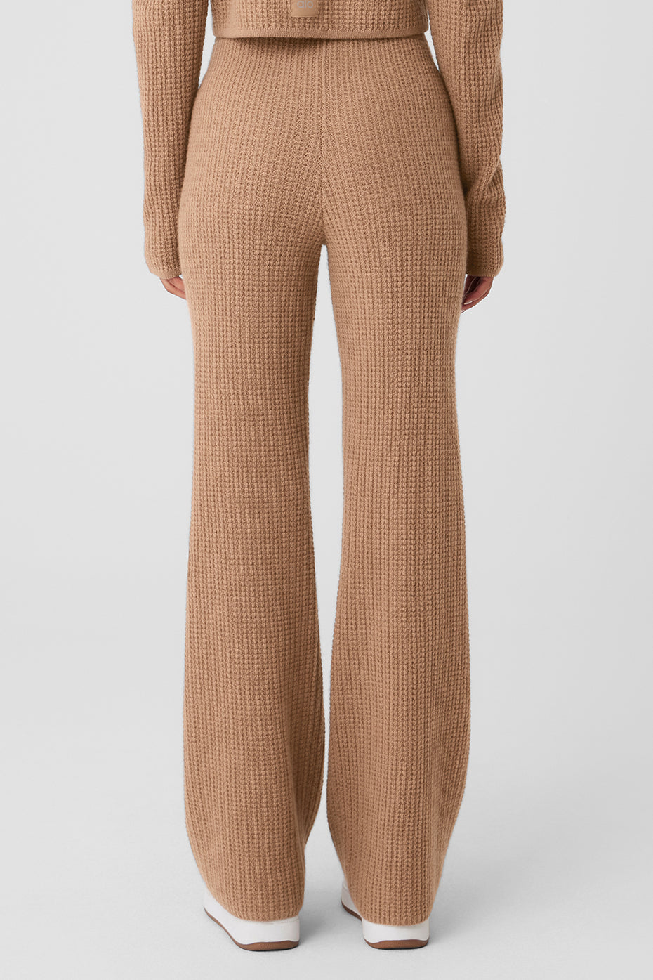 Model wearing waffle knit loungewear with wide leg cashmere pants.