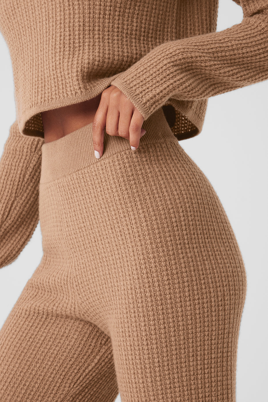 Side view of soft cashmere pants, showcasing the high-rise waistband.