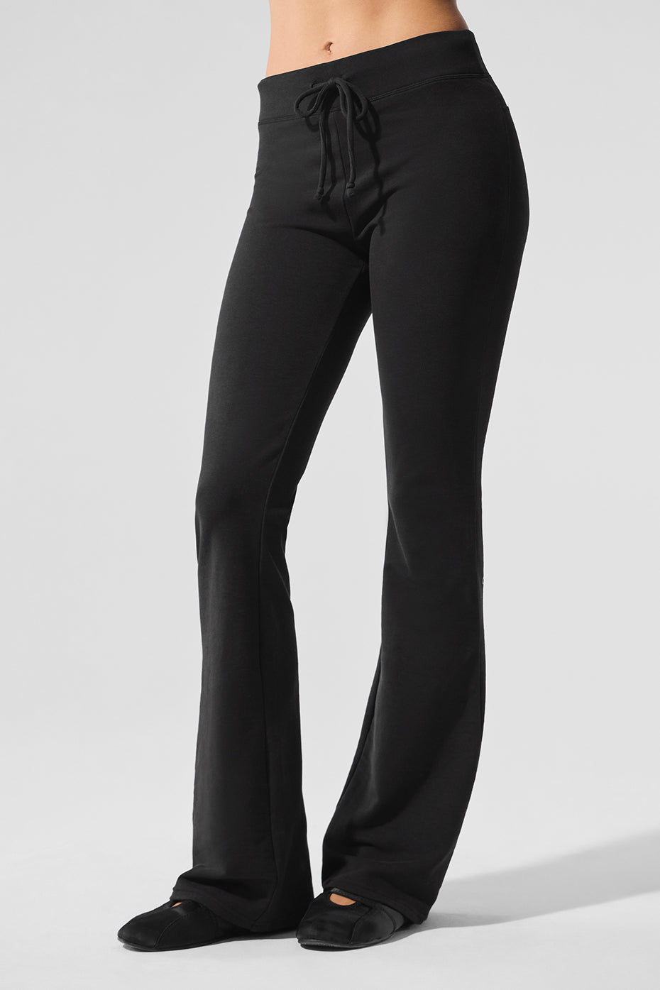 Front view of black bootcut sweatpants with tailored lines for women and men