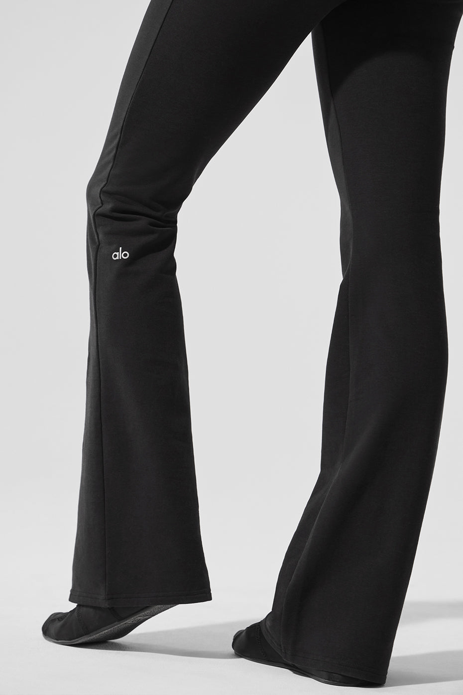 Front view of black bootcut sweatpants with tailored lines for women and men