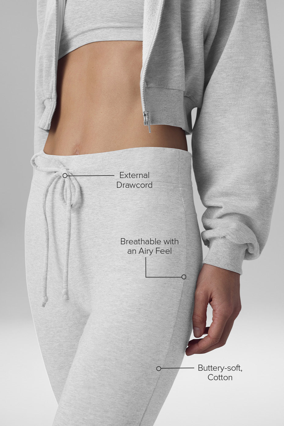 Model wearing athletic heather grey bootcut sweatpants with a fitted top