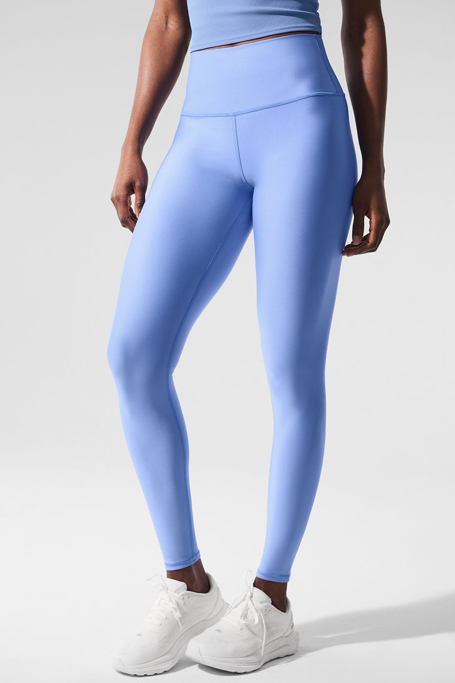Side view of compression leggings highlighting the double-layered waistband and ankle length.