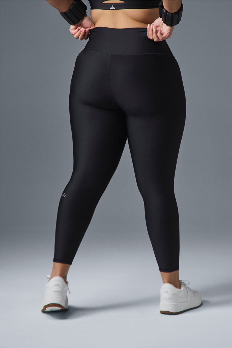 Back view of black compression leggings for women, emphasizing the sleek design.