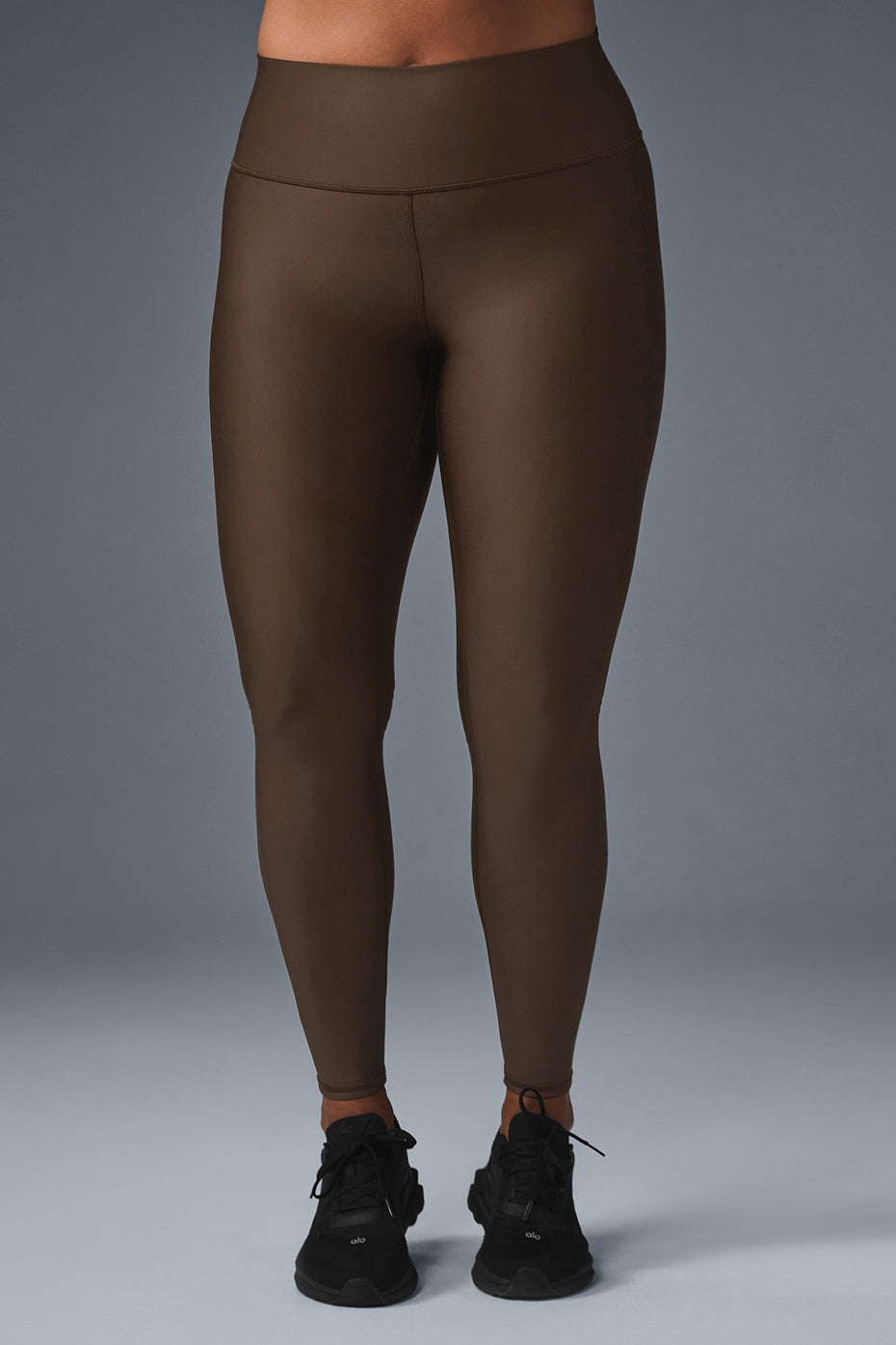 Model wearing espresso high-waist leggings during a workout outdoors