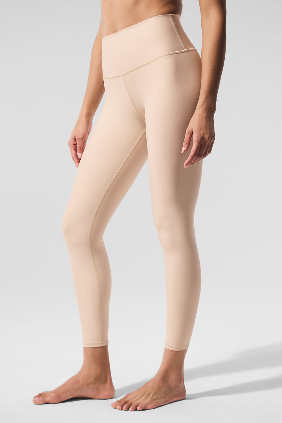 Back angle of woman walking through Chicago park in Airlift leggings
