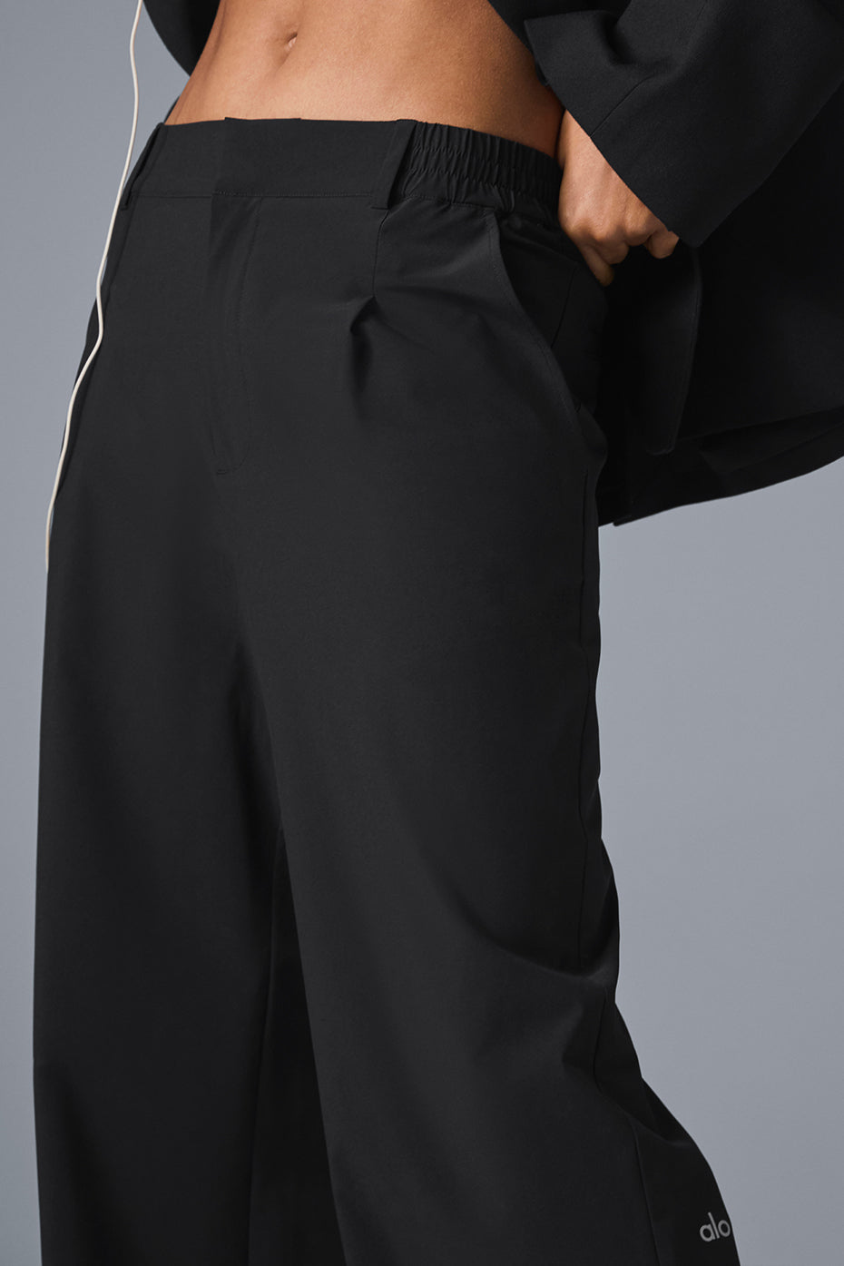 Close-up of the tailored details on Elevate Black High-Waist Trousers.