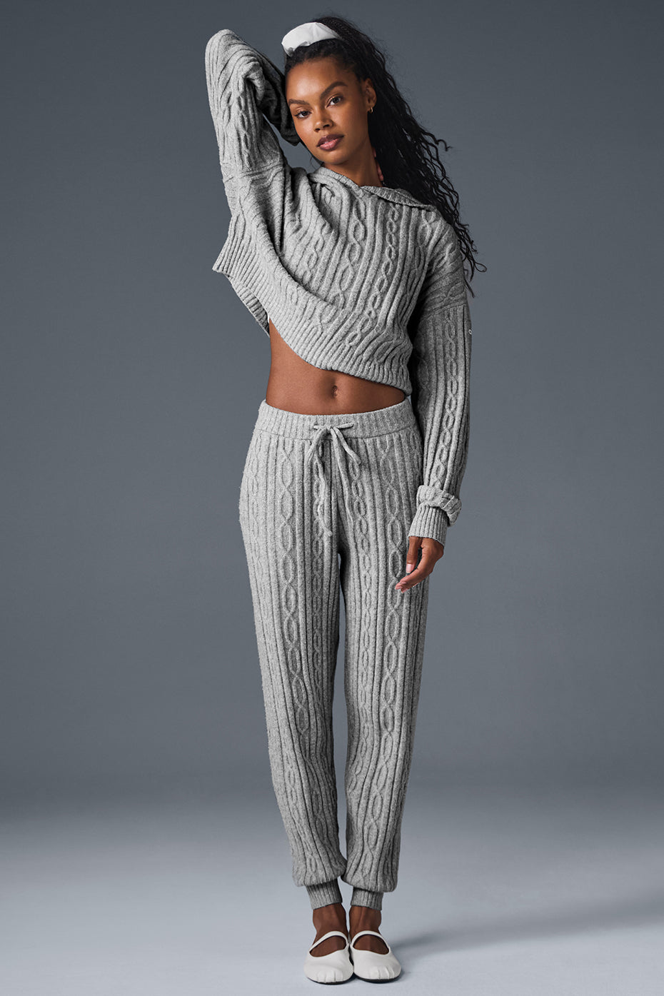 Cable knit winter lounge pants from the side, showing relaxed fit and ankle cuffs.