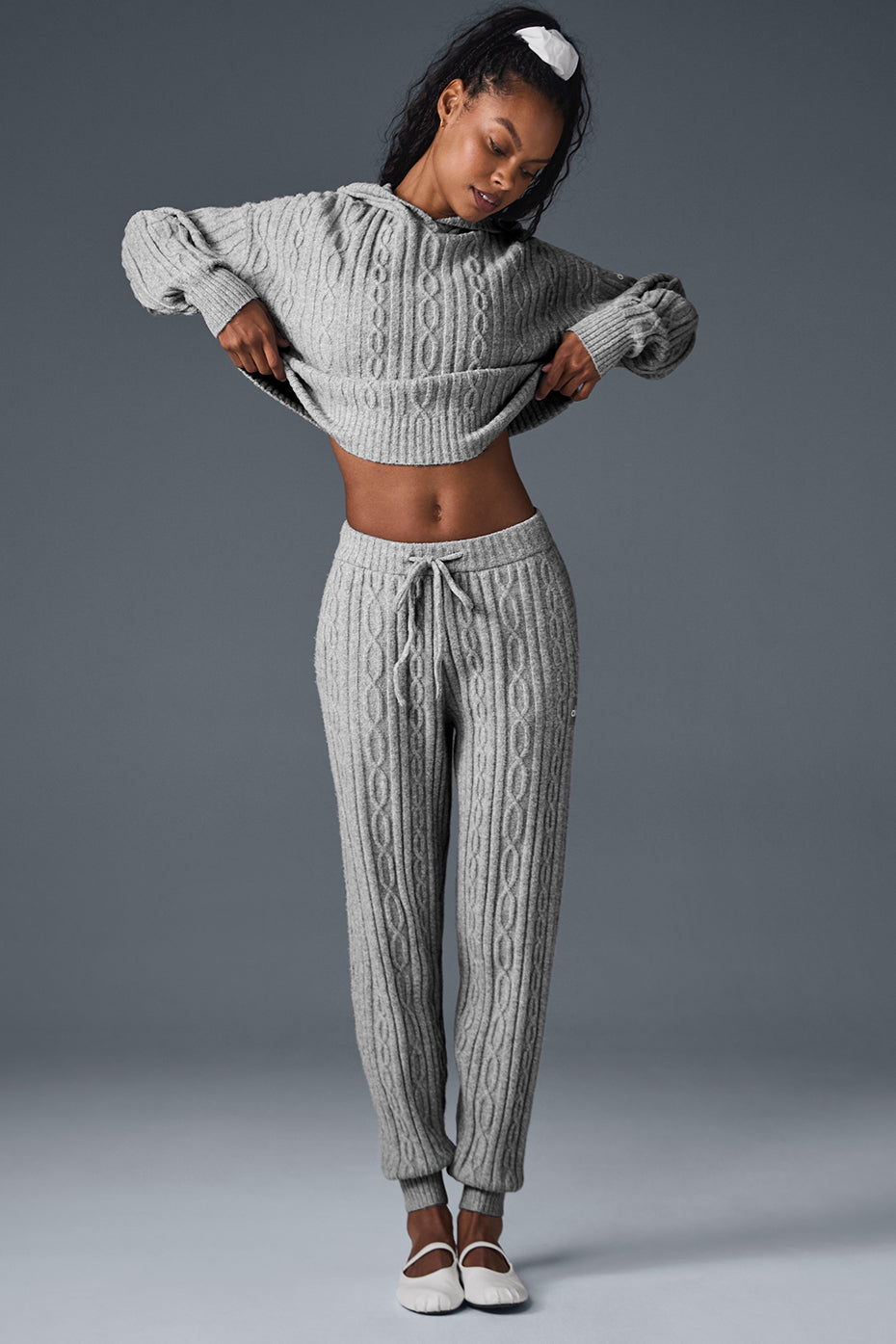 Cable knit winter lounge pants from the side, showing relaxed fit and ankle cuffs.