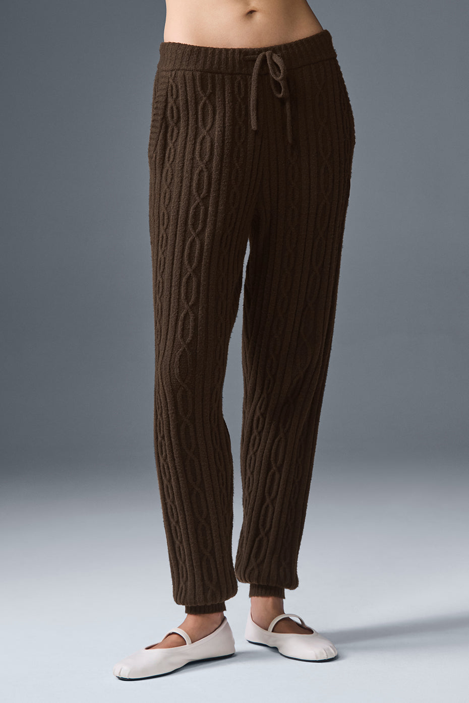 Cozy Cable Knit Winter Pants displayed near a fireplace, emphasizing warmth and style.