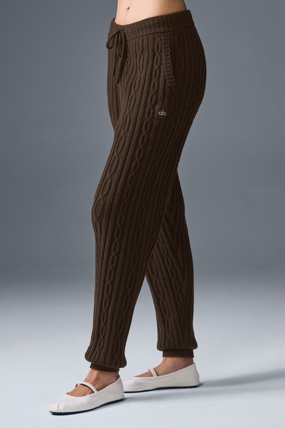 Cozy Cable Knit Winter Pants displayed near a fireplace, emphasizing warmth and style.