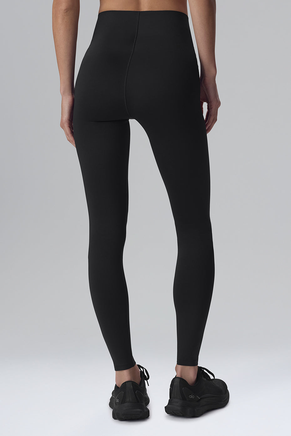 Woman running in compression leggings, showcasing fit