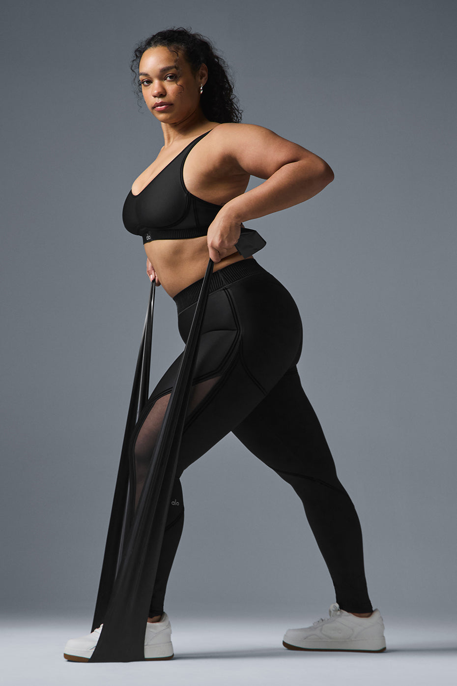 Side view of high-waist leggings with mesh panels during a workout.