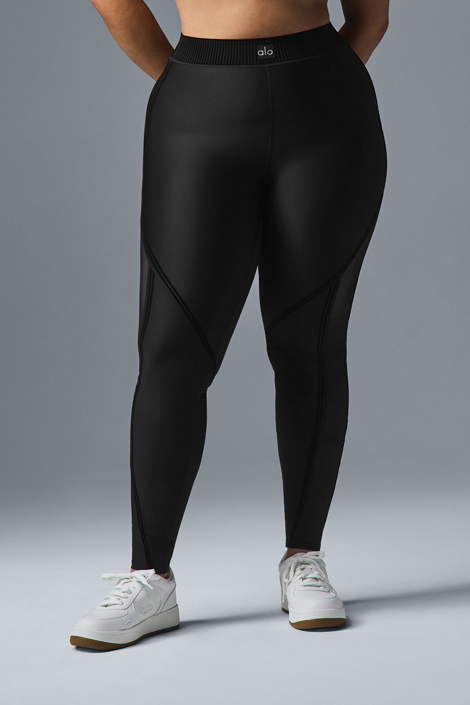 Close-up of the ribbed waistband on black mesh leggings.