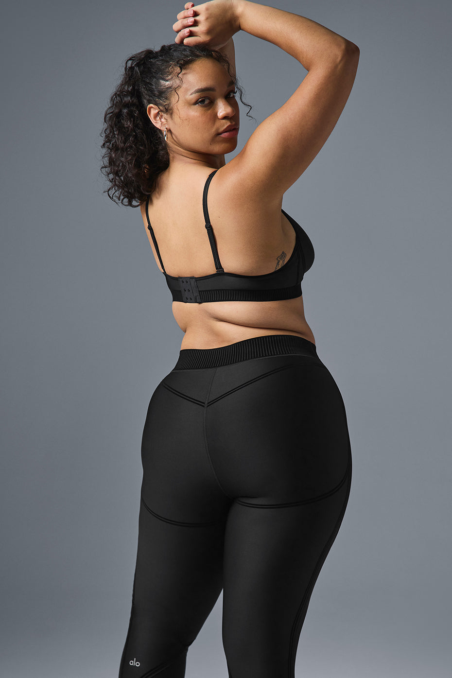 Close-up of the ribbed waistband on black mesh leggings.