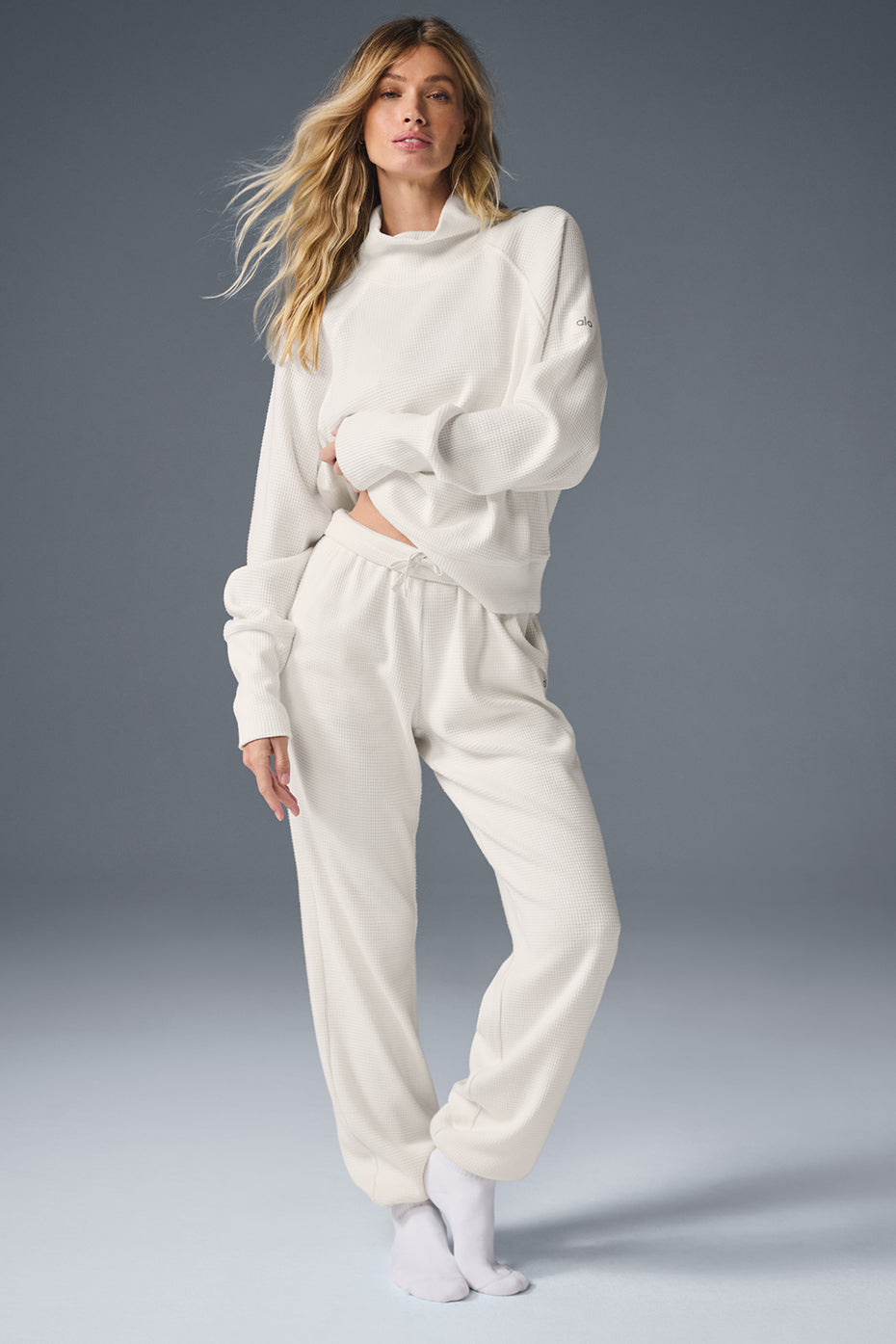 Woman wearing ivory waffle knit joggers with a relaxed sweater