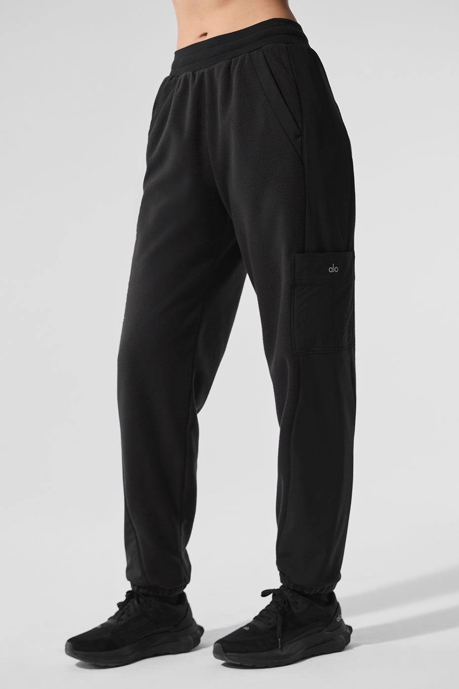 Model wearing cozy fleece jogger pants during a winter outing.