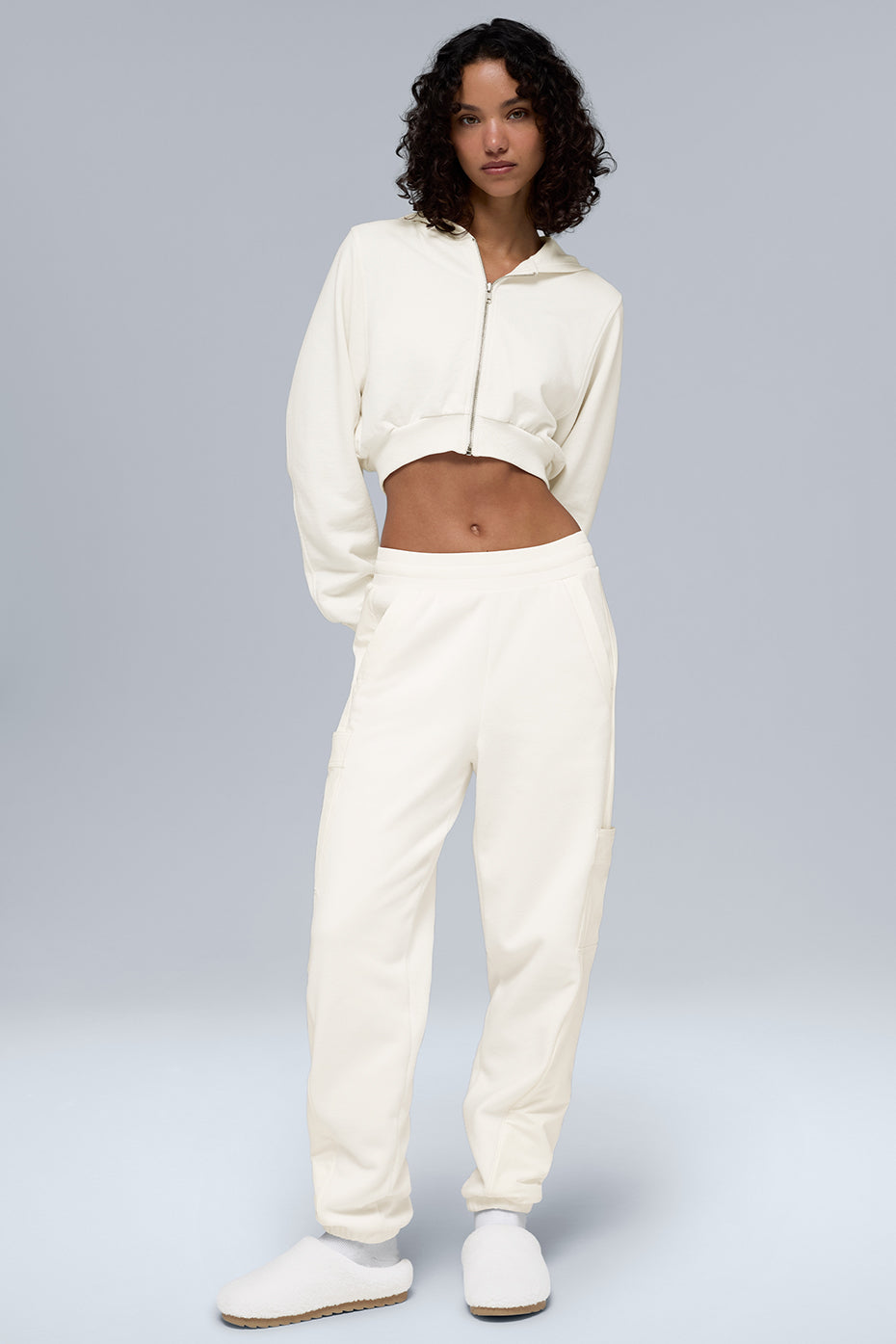 Front view of cozy ivory fleece joggers styled with winter accessories.