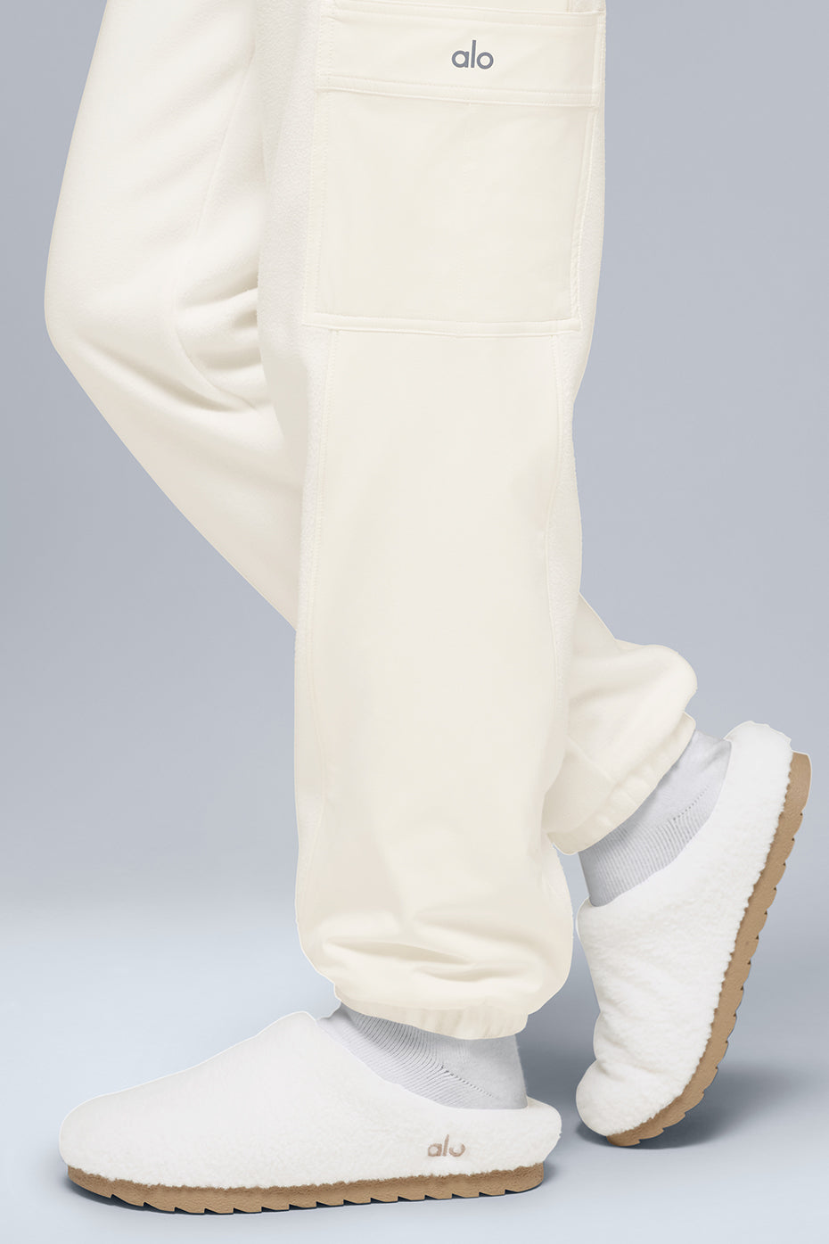 Front view of cozy ivory fleece joggers styled with winter accessories.