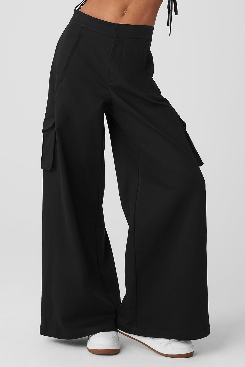 Front view of black wide leg cargo trousers for women, showcasing pockets.
