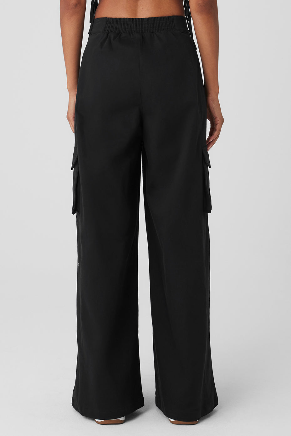 Back view of high waist trousers, highlighting the stretchy waistband.