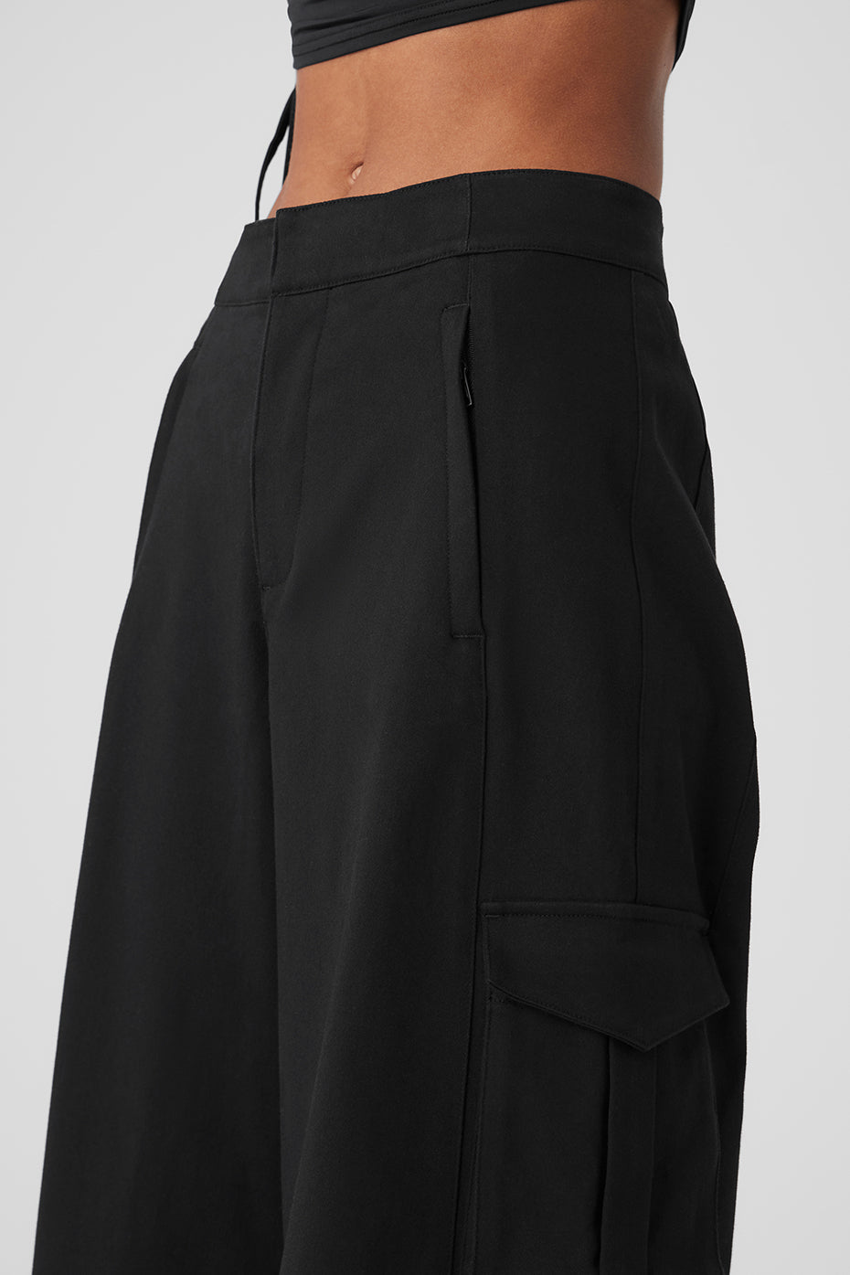 Front view of black wide leg cargo trousers for women, showcasing pockets.