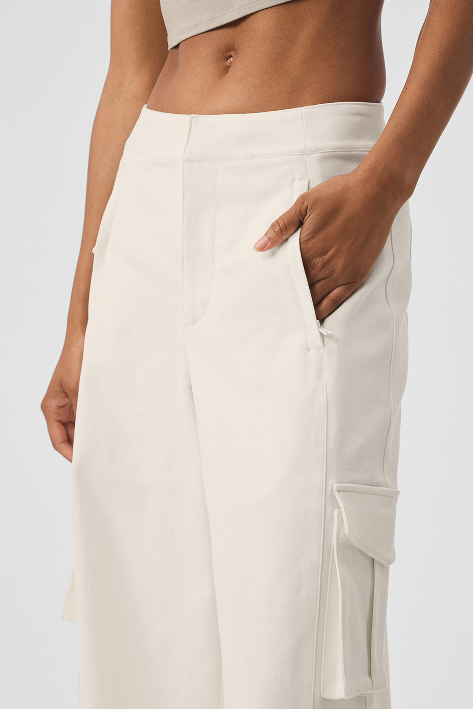 Front view of ivory wide leg cargo trousers for women, highlighting the cargo pockets.