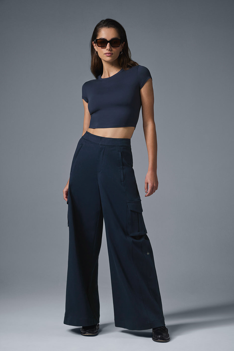 Front view of navy wide leg cargo trousers for women, highlighting the cargo pockets.