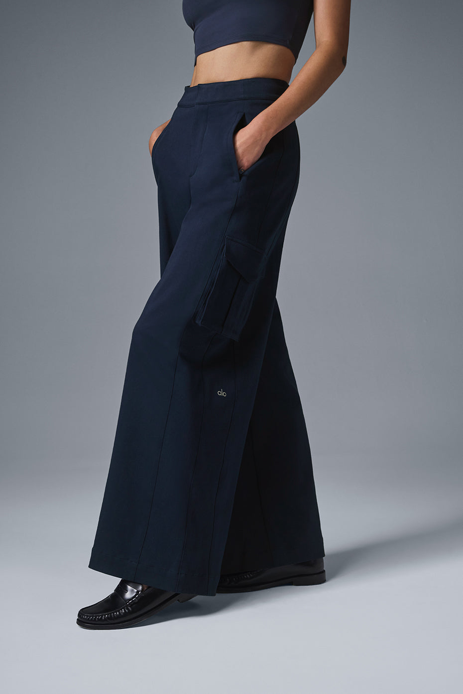Side view of womens navy cargo trousers, emphasizing the exaggerated wide leg design.