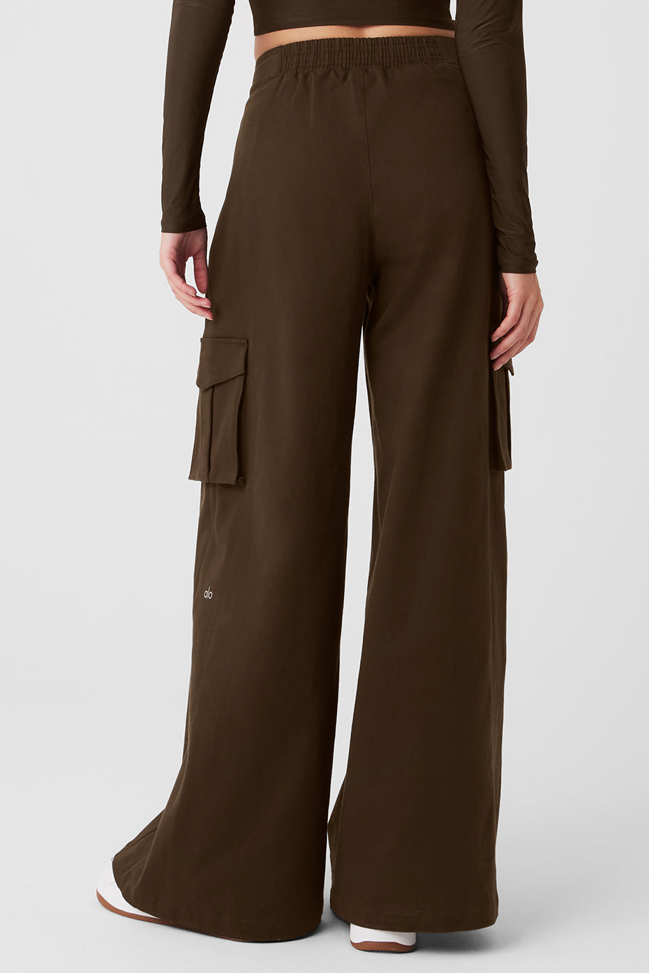 Model styling high waist trousers with crop top for casual streetwear look