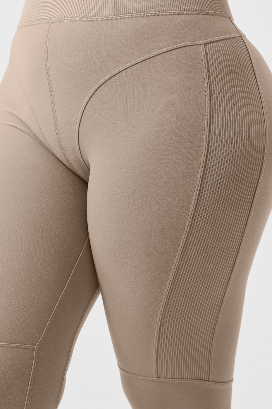 Model wearing full-length leggings with contrasting ribbed panels and matching sports bra