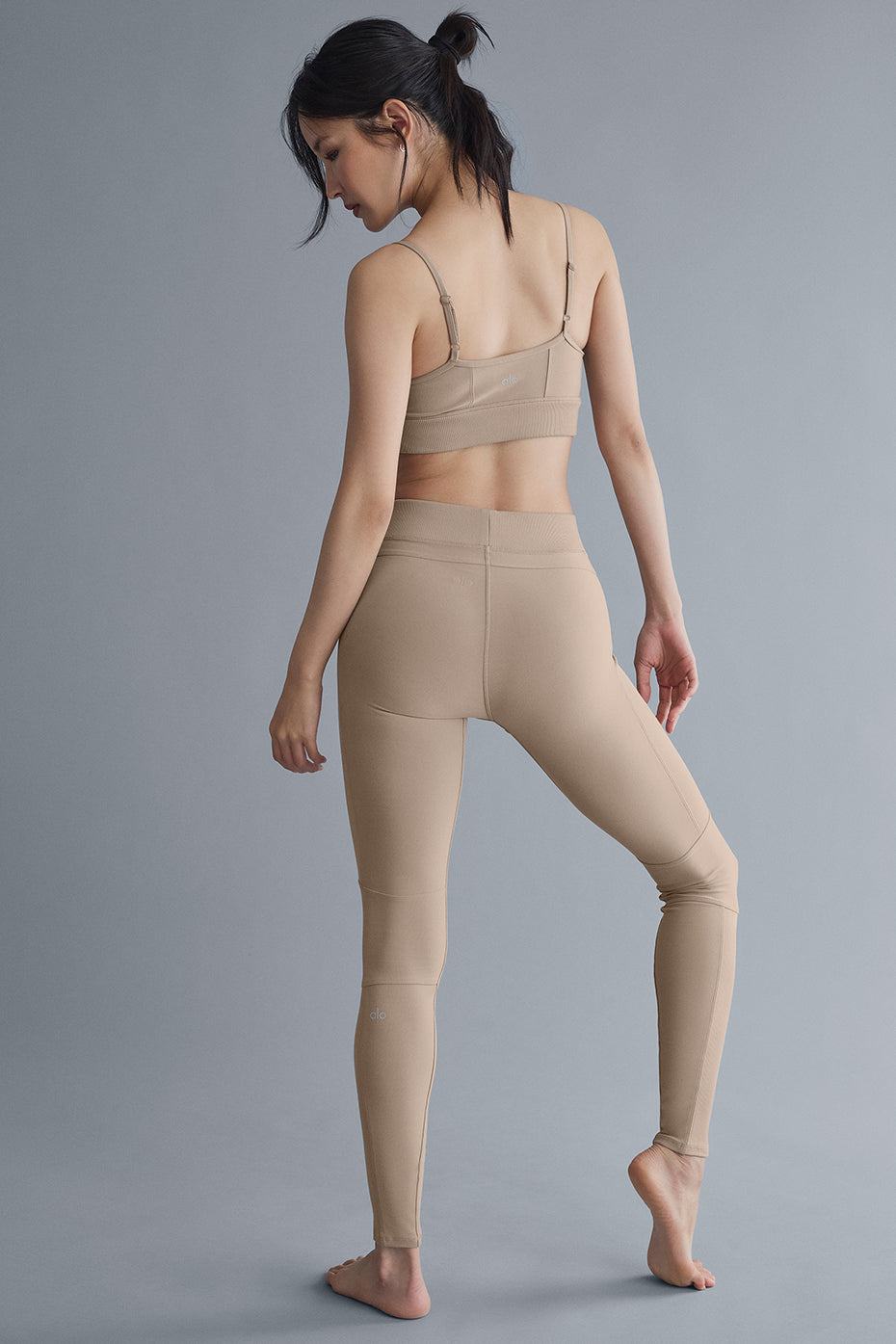 Side view of high-waist yoga pants with ribbed panels and elastic waistband in Gravel