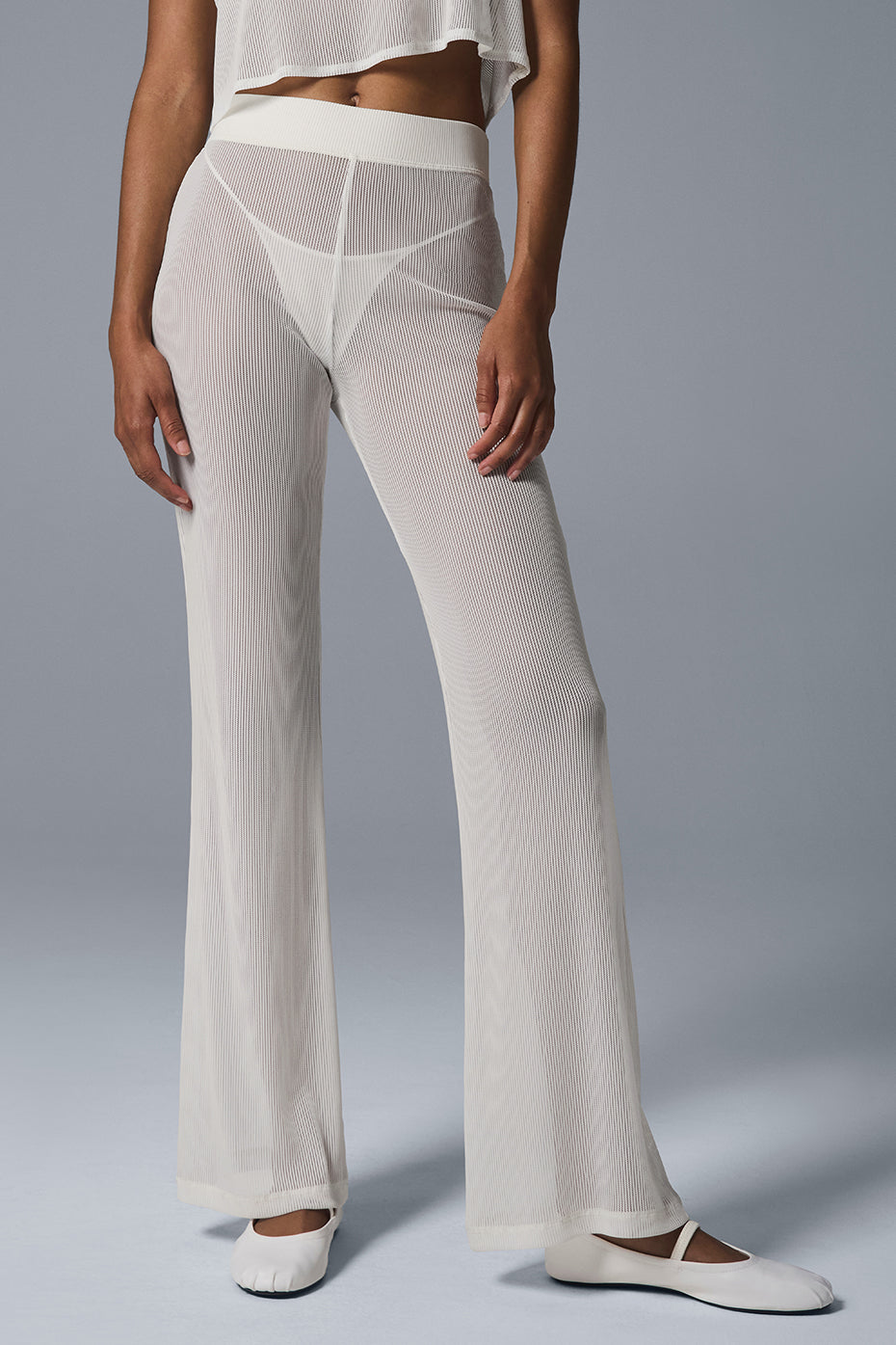 Close-up of the high-rise elastic waist of the flare pants.