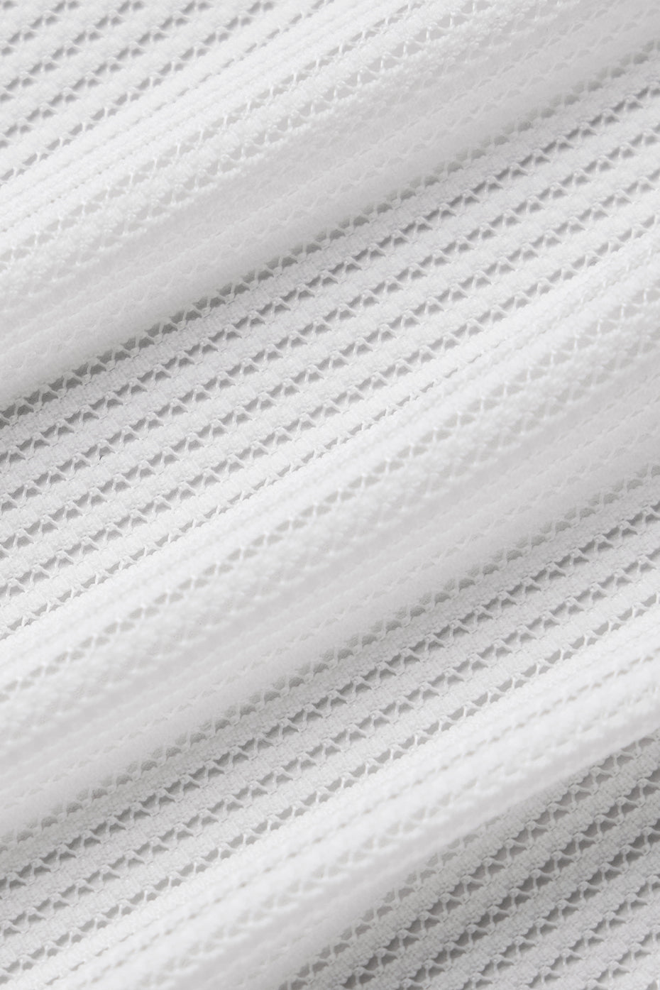 Side view showcasing the flared legs of the mesh pants.
