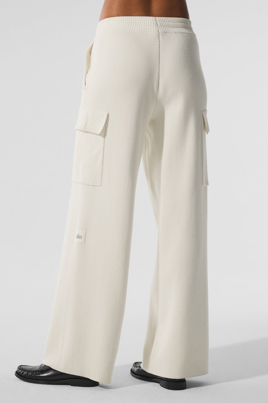 Model seated in comfort cargo pants showcasing relaxed fit and utility pockets
