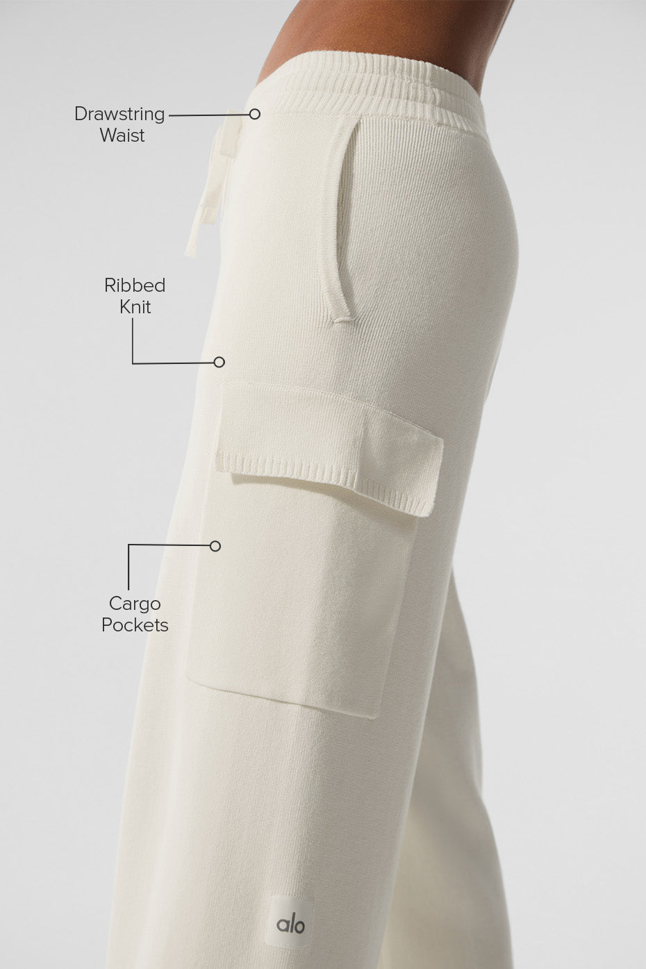Side profile of ivory cargo pants paired with a cropped puffer jacket in fall setting