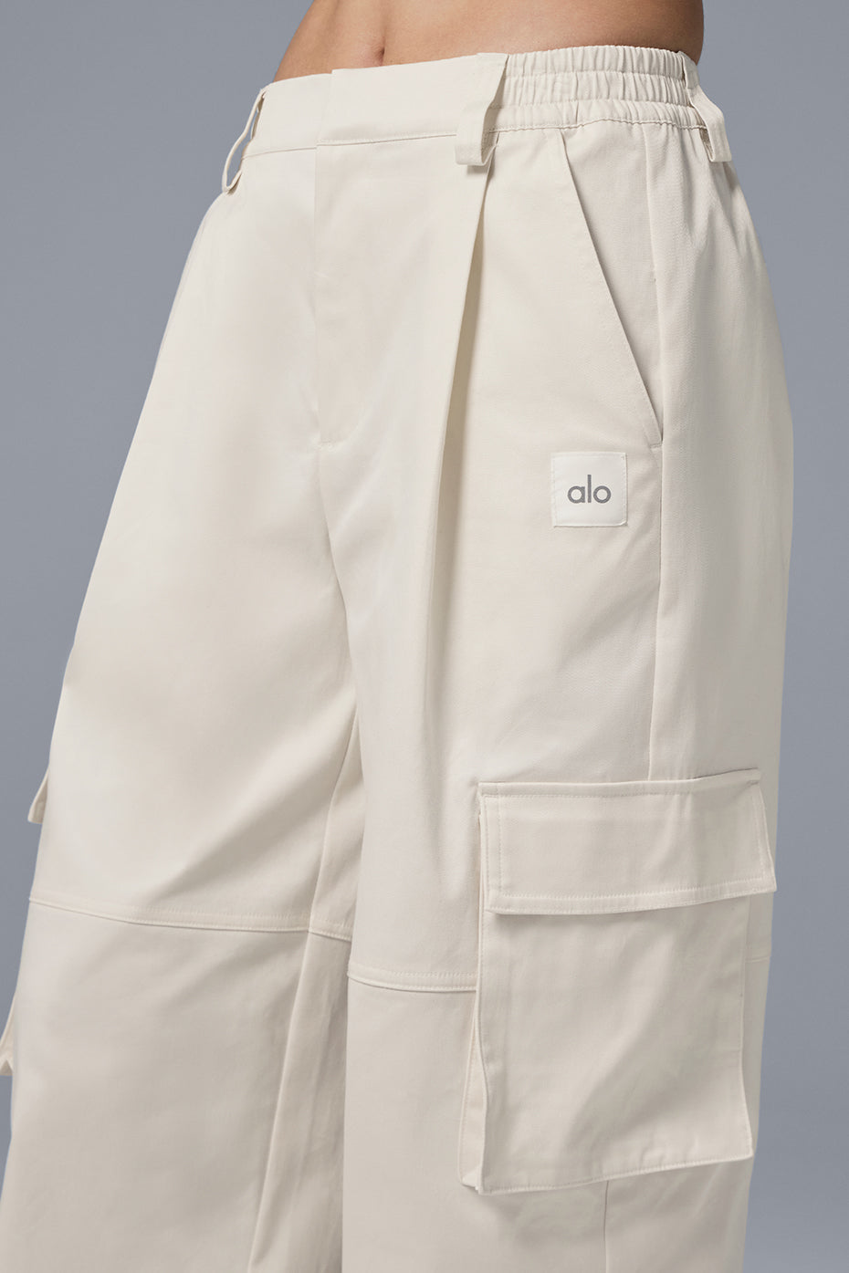 Back view emphasizing the stretchy waistband of the trousers