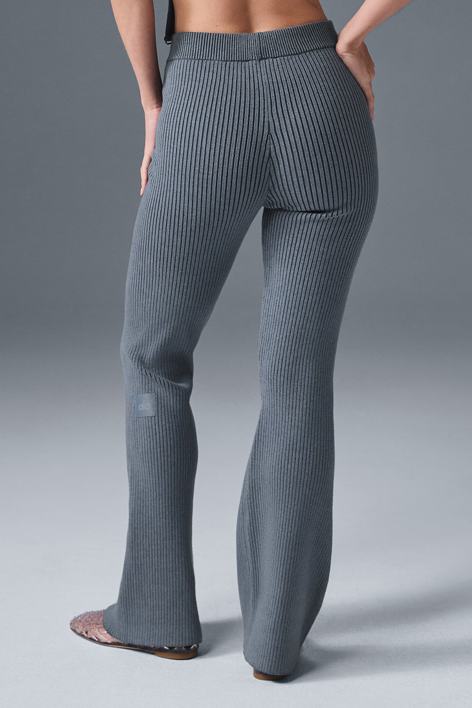 Close-up of denim knit pants texture and flared hem detail