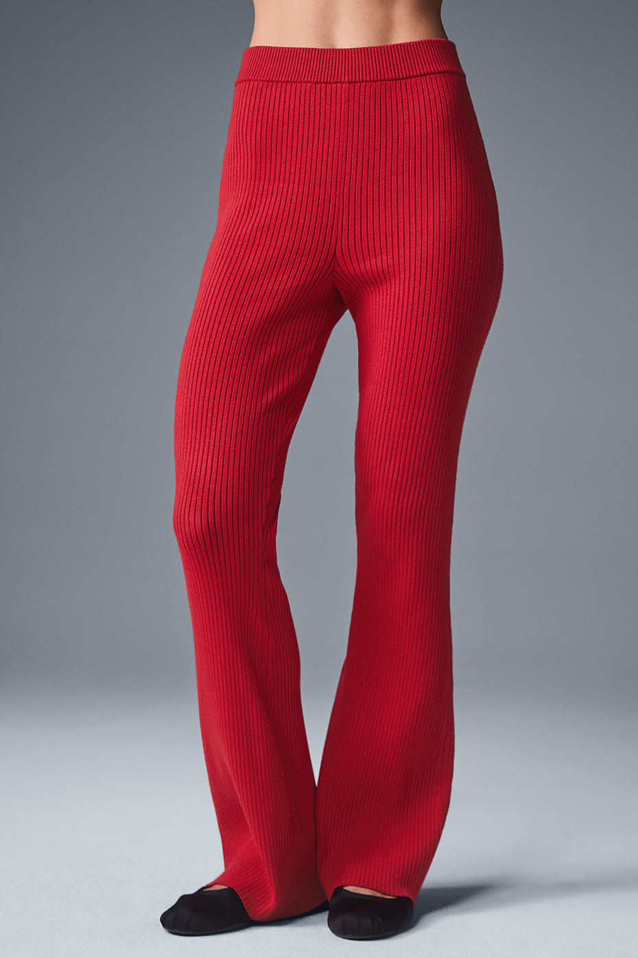 Front view of ribbed knit high waist flare pants in bold red.